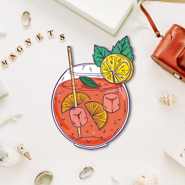 A miniature, vibrant orange mocktail-shaped fridge magnet with an orange slice.