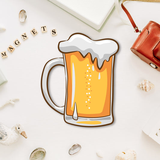 A miniature glass of beer-shaped fridge magnet with a foamy head.