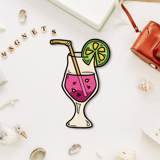 A vibrant, miniature cocktail glass-shaped fridge magnet with a straw and garnish.