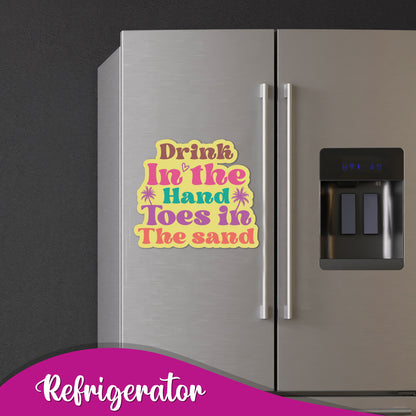 Close-up of the quote "The secret to a happy life is to have a drink in your hand" on a magnet.