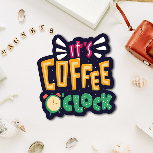 "It's Coffee O'Clock" quote fridge magnet with a cup illustration.