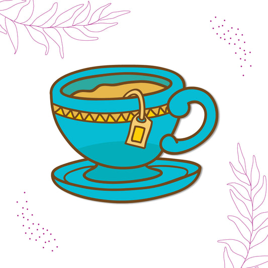 Close-up of a cute tea cup magnet on a refrigerator.