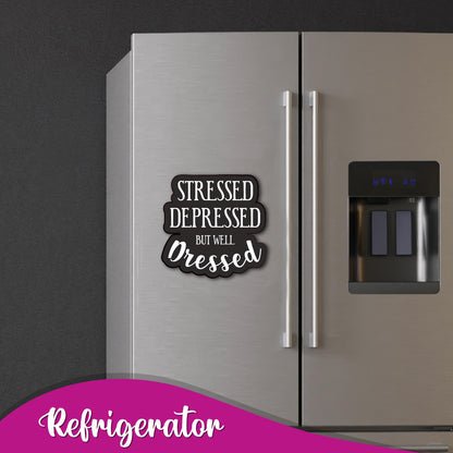 Close-up of the "Stressed but Well Dressed" text on a magnet.