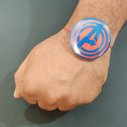 Avengers Rakhi shown both on a thread and as a fridge magnet