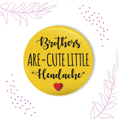 Brothers are Cute Little Headache metal magnet stuck to a refrigerator door.