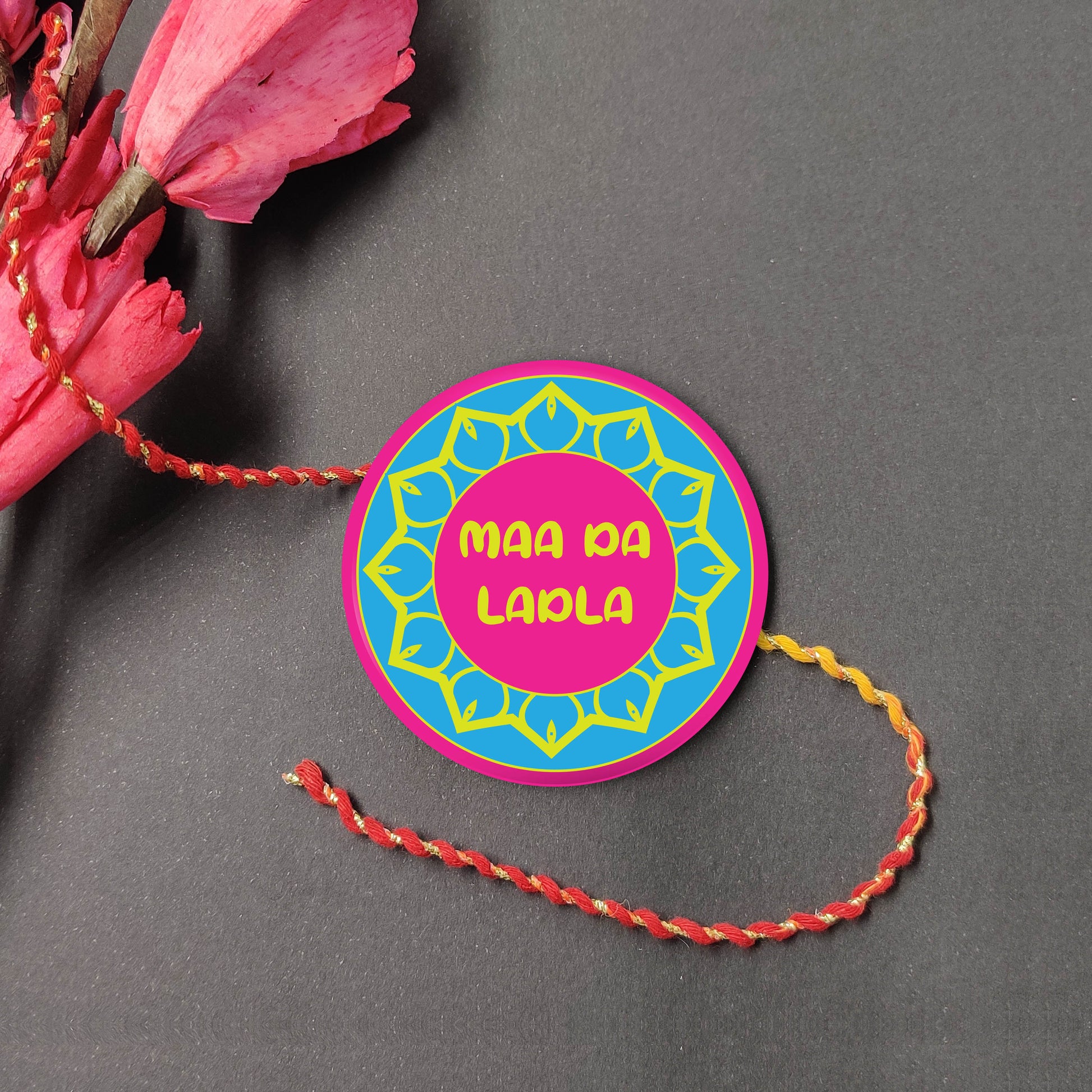 Maa Da Ladla Metal Rakhi on a thread, with Roli and Chawal for Raksha Bandhan.