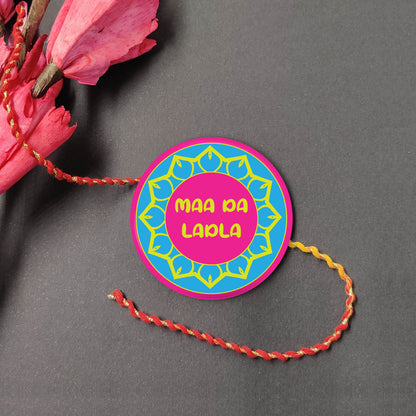 Maa Da Ladla Metal Rakhi on a thread, with Roli and Chawal for Raksha Bandhan.