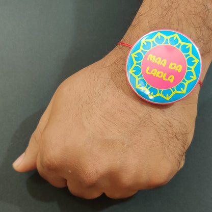 Maa Da Ladla Rakhi shown both on a thread and as a fridge magnet.