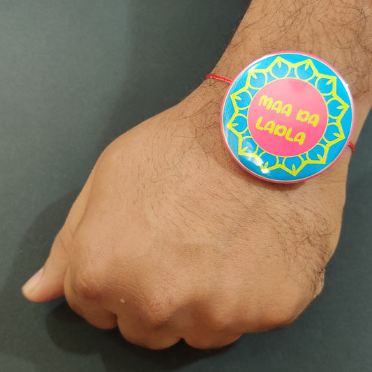 Maa Da Ladla Rakhi shown both on a thread and as a fridge magnet.