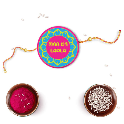 Close-up detail of 'Maa Da Ladla' inscription on metal Rakhi and magnet.