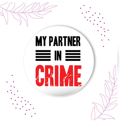 Partner in Crime metal magnet stuck to a refrigerator door.