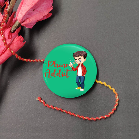 Phone Addict Metal Rakhi on a thread, with Roli and Chawal for Raksha Bandhan.