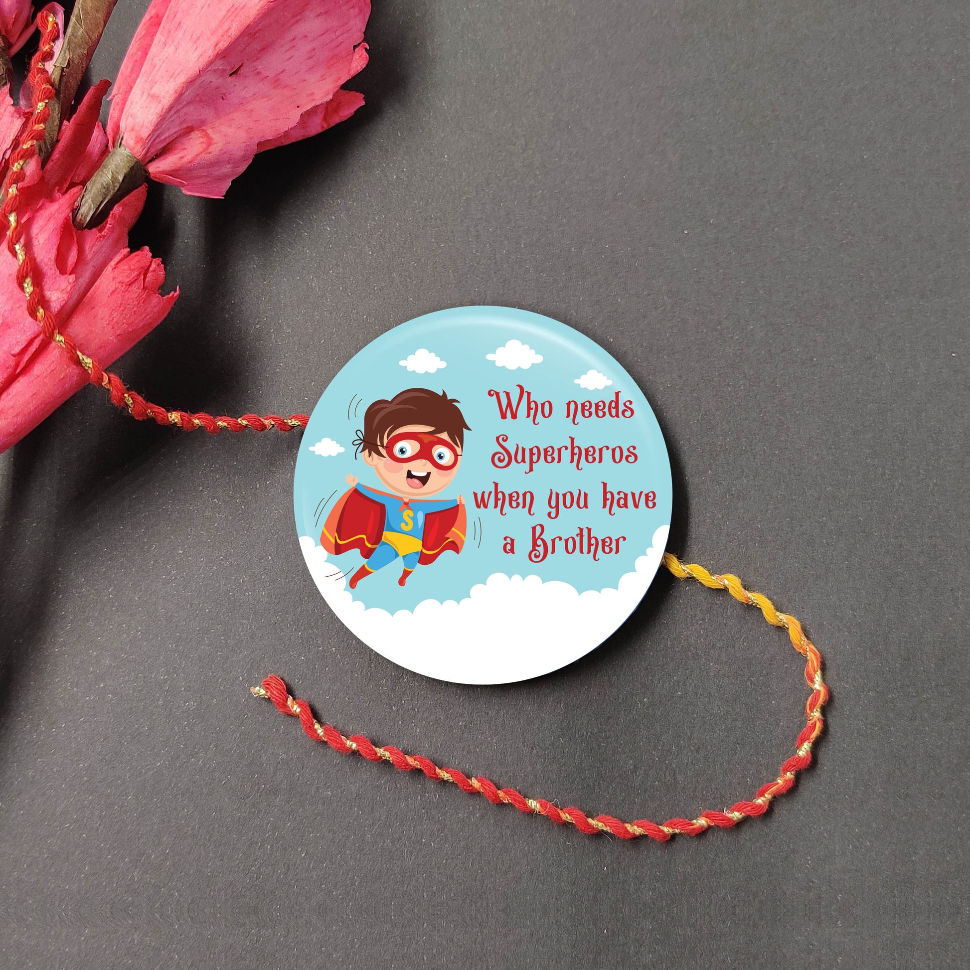 Brother is Superhero Metal Rakhi on a thread, with Roli and Chawal for Raksha Bandhan.