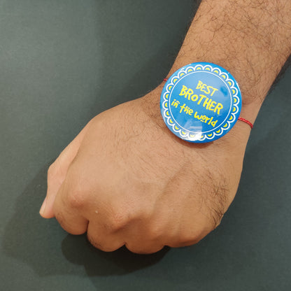 Best Brother in the World Rakhi shown both on a thread and as a fridge magnet.