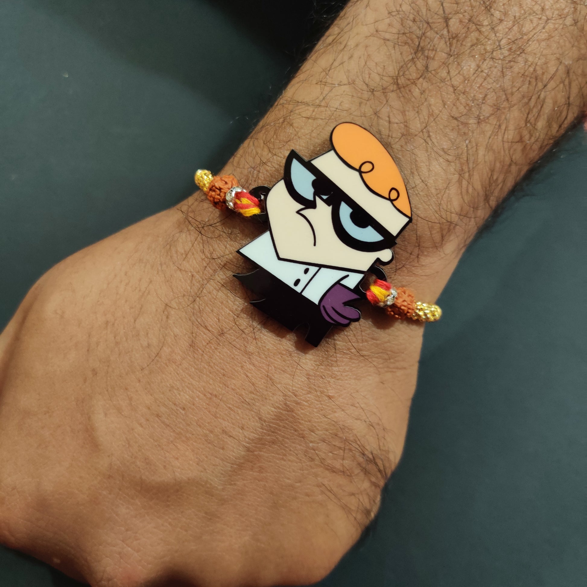 Intelligent Dexter Wooden Rakhi with Rudraksha thread worn on a brother's wrist.