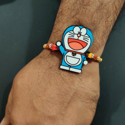 Charming Doraemon Wooden Rakhi with Rudraksha thread worn on a brother's wrist.