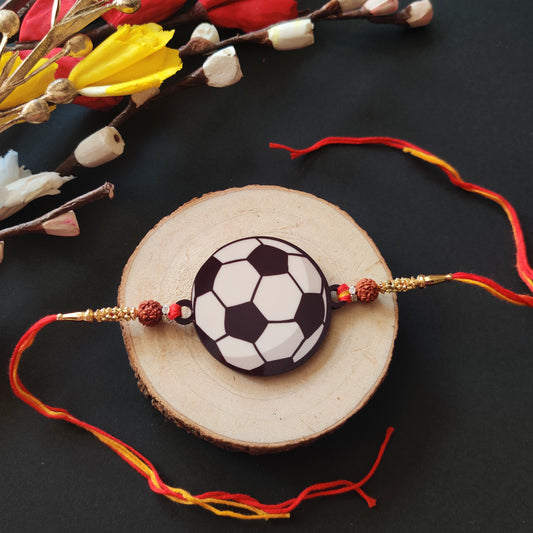 Football Wooden Rakhi with Rudraksha thread, presented with Roli and Chawal for Raksha Bandhan.