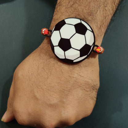 Football fan brother wearing Football Wooden Rakhi with Rudraksha thread on his wrist.