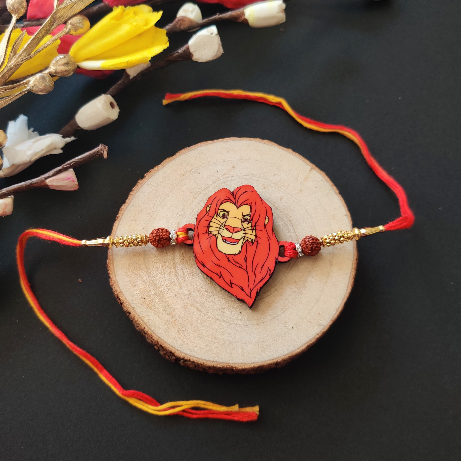 Mufasa Wooden Rakhi with Rudraksha thread, presented with Roli and Chawal for Raksha Bandhan.