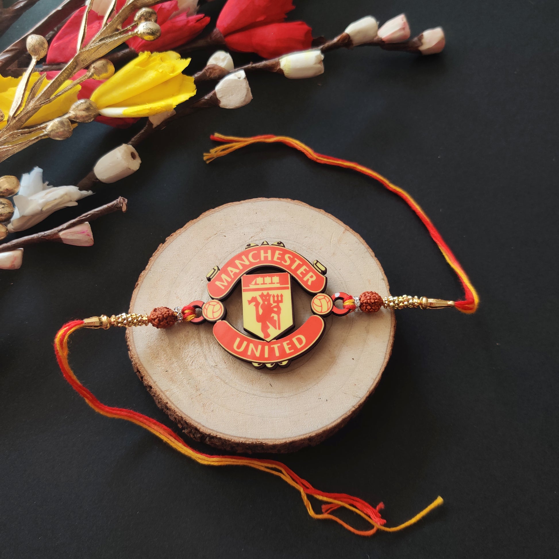 Manchester United Wooden Rakhi with Rudraksha thread, presented with Roli and Chawal for Raksha Bandhan.