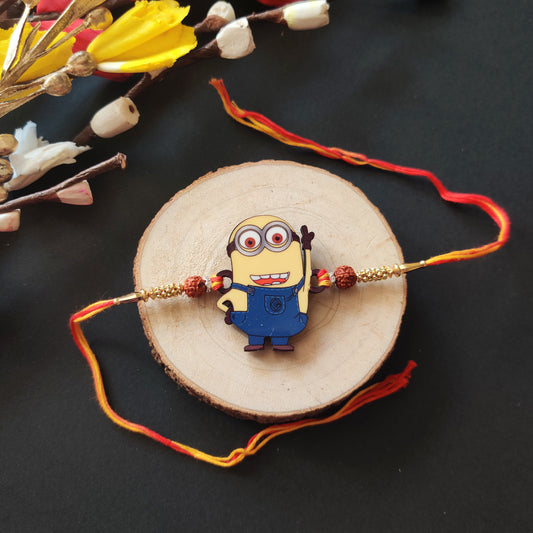 Minion Wooden Rakhi with Rudraksha thread, presented with Roli and Chawal for Raksha Bandhan.