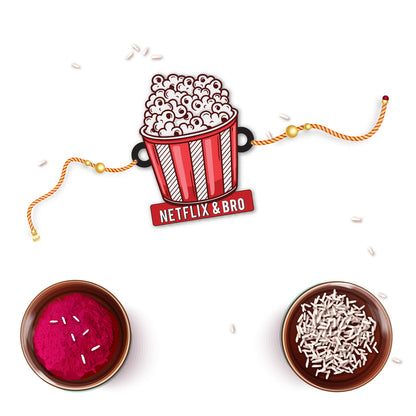 Netflix & Bro Wooden Rakhi with Rudraksha displayed next to popcorn and a cozy blanket