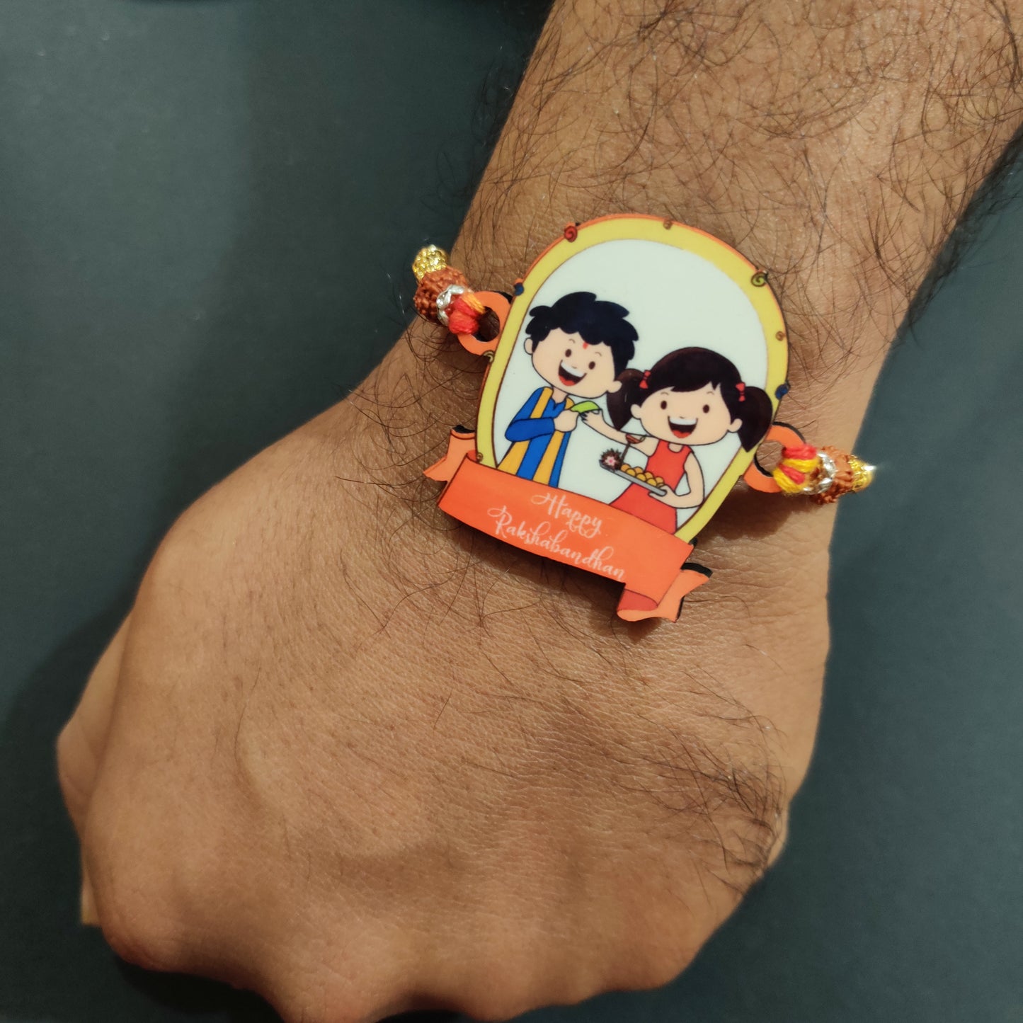 Traditional Happy Rakshabandhan Wooden Rakhi with Rudraksha thread worn on a brother's wrist