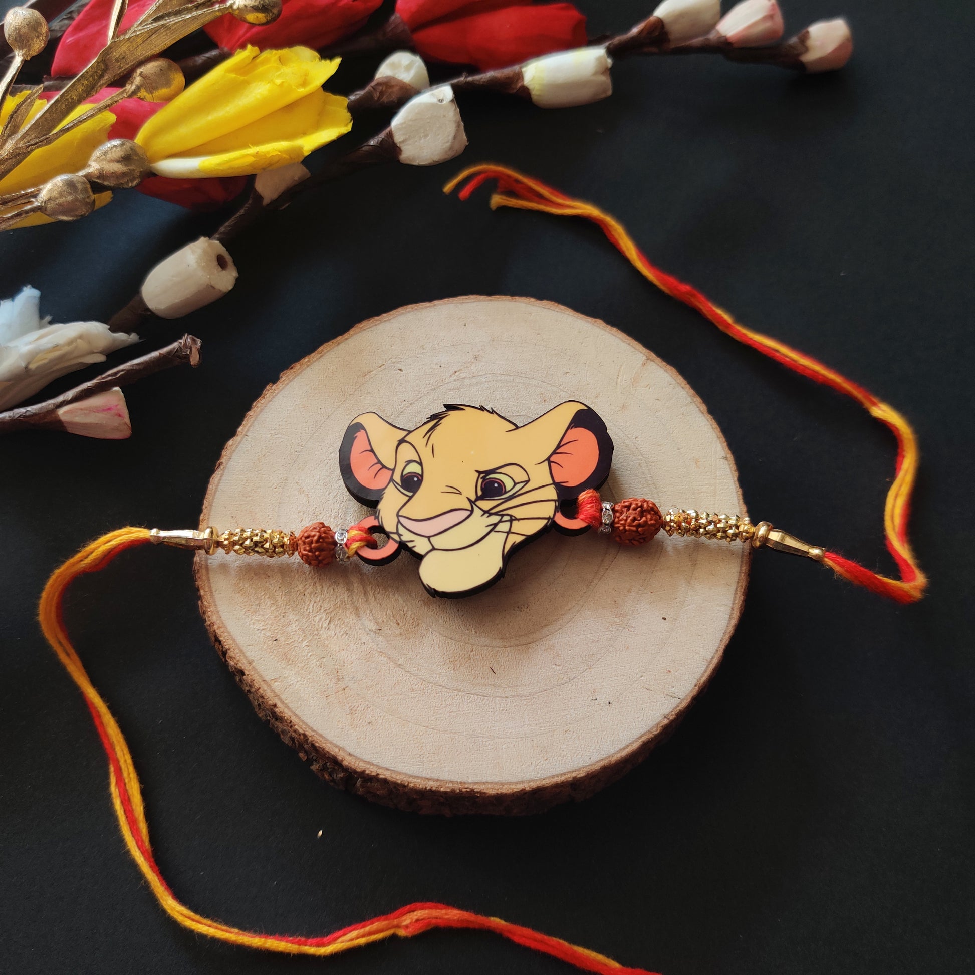 Simba Wooden Rakhi with Rudraksha thread, presented with Roli and Chawal for Raksha Bandhan