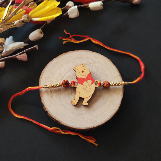 Winnie Pooh Wooden Rakhi with Rudraksha thread, presented with Roli and Chawal for Raksha Bandhan.